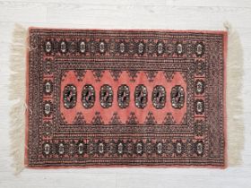 A Bokhara style rug. H.109 W.65cm.