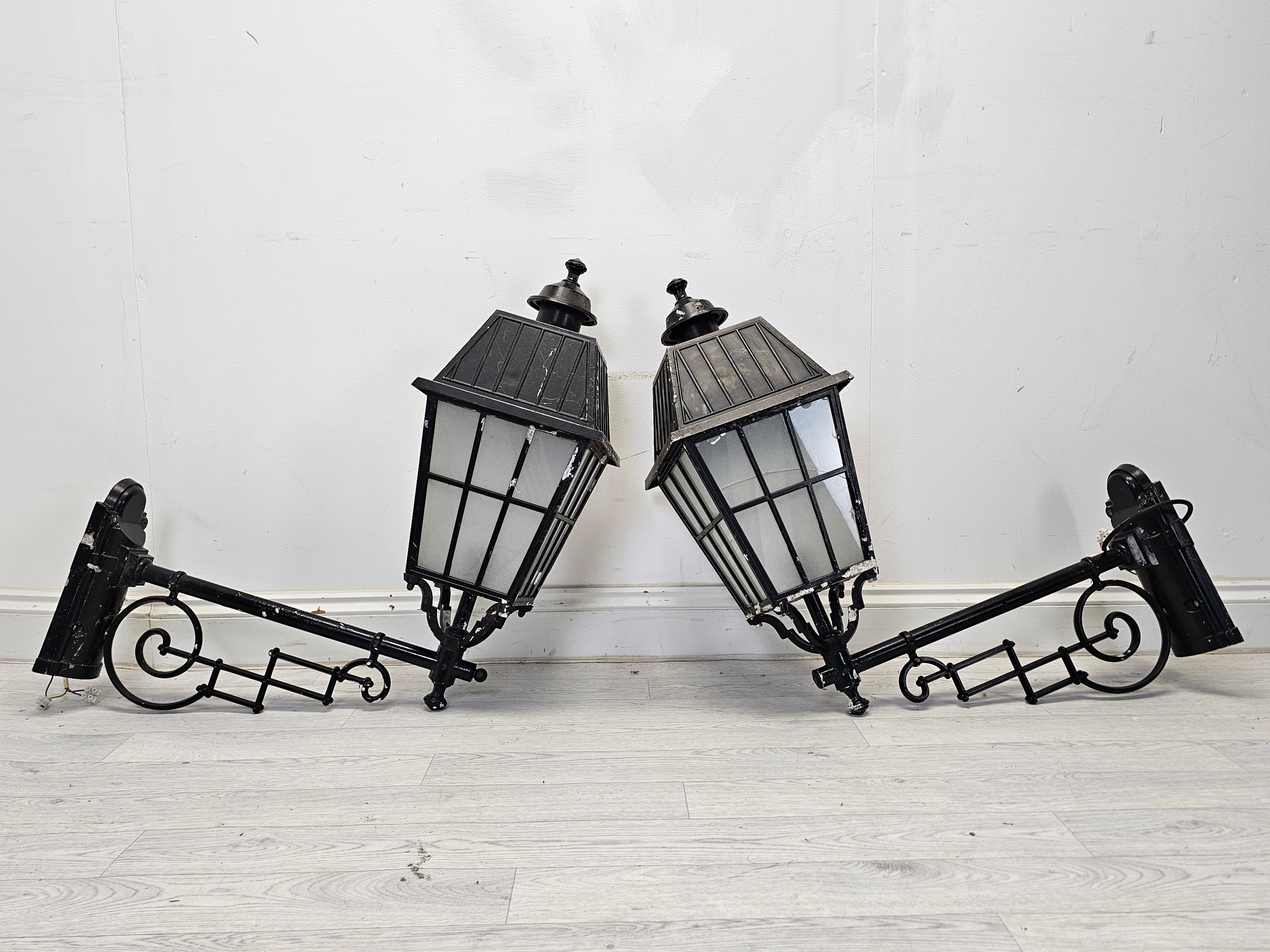 A pair of Victorian style metal wall mounted street lanterns. H.80 W.72 D.28cm (each)