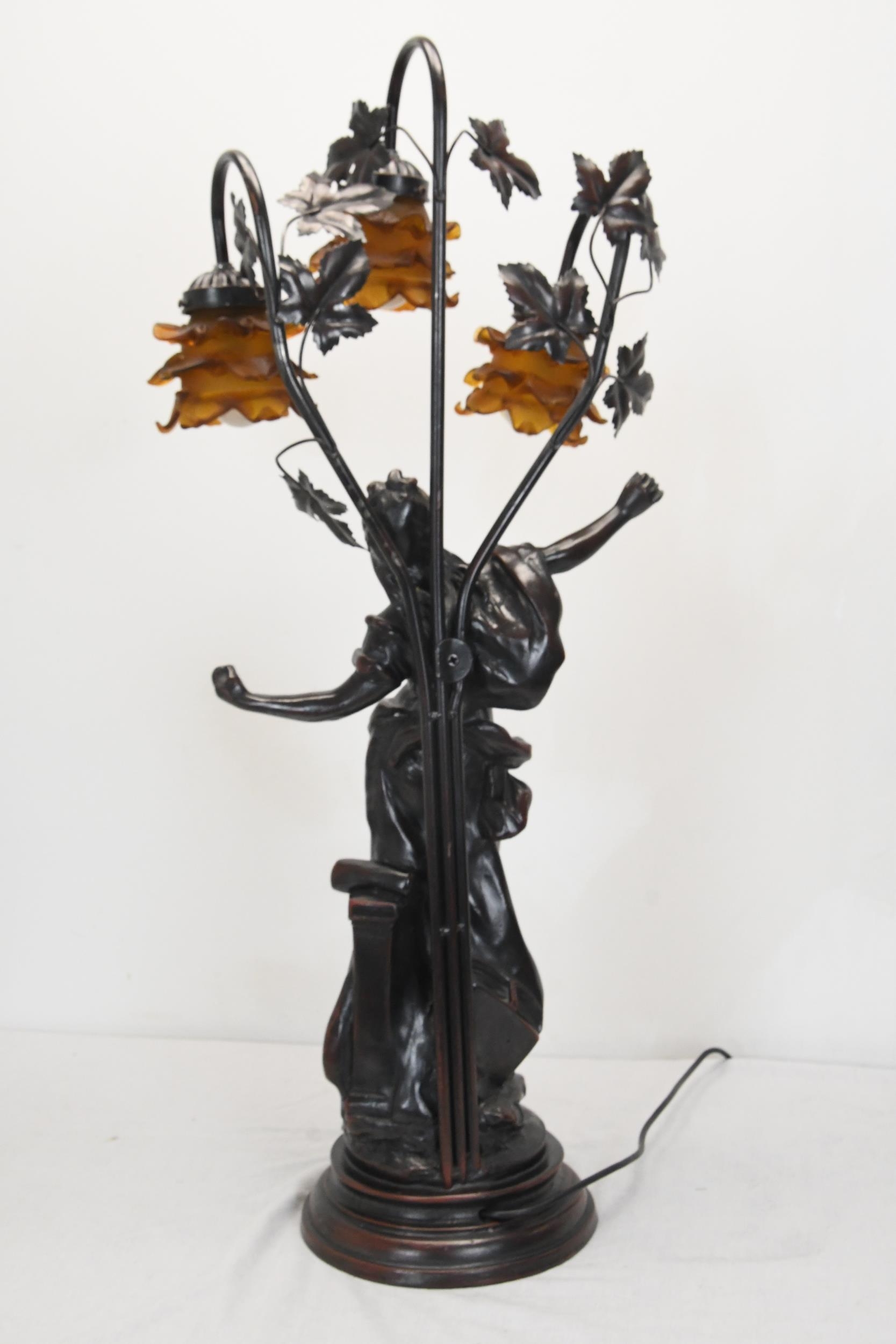 A 20th century spelter classical figural three branch table lamp, the floral shades of moulded amber - Image 3 of 5