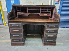 A late 19th century oak roll top desk. H.150 W.138 D.77cm.