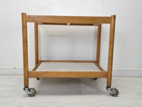 A vintage beech and composite laminated drinks or tea trolley. H.70 W.75 D.46cm.