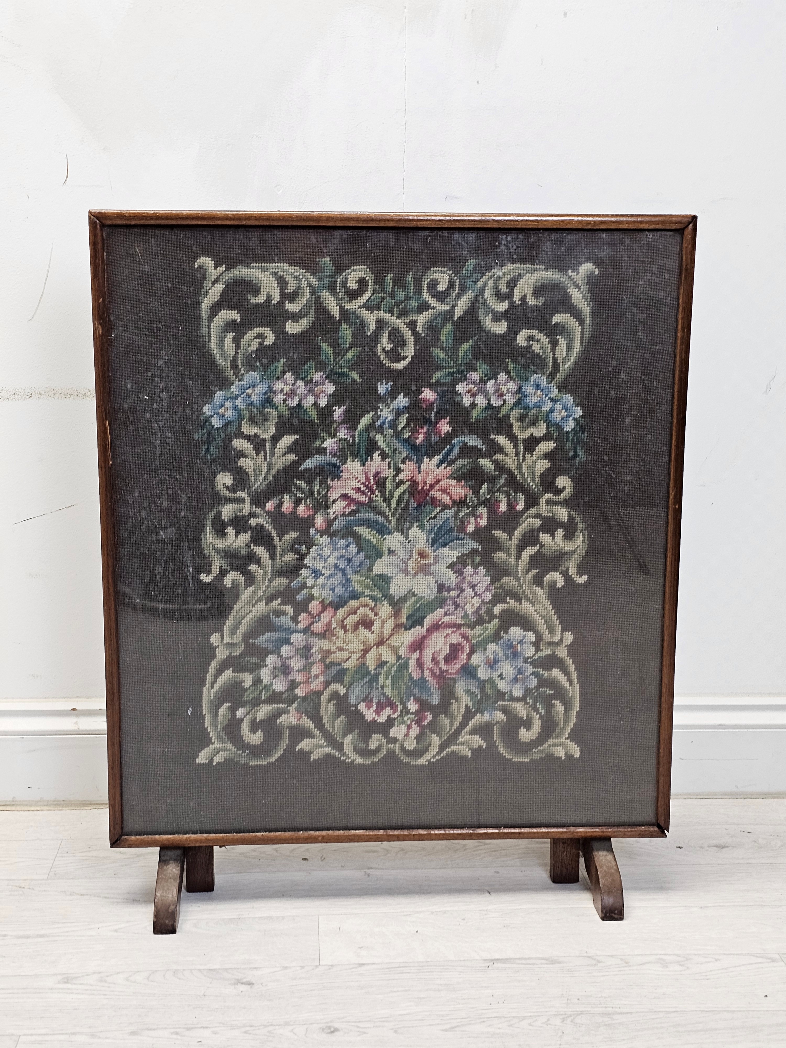 A mid century glazed tapestry fire guard in an oak frame converting to a gateleg occasional table.