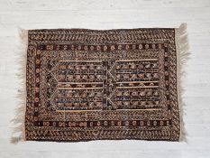 An Eastern prayer rug. L.136 W.89cm.