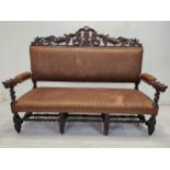 A late 19th century carved oak hall bench. H.127 W.170 D.65cm.