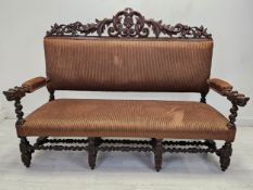 A late 19th century carved oak hall bench. H.127 W.170 D.65cm.