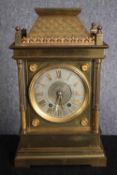 A 19th century brass architectural design mantle clock with tile detailing to the roof. Silvered