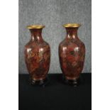 A matching pair of Chinese cloisonné vases on carved hardwood stands. Hand painted enamel on