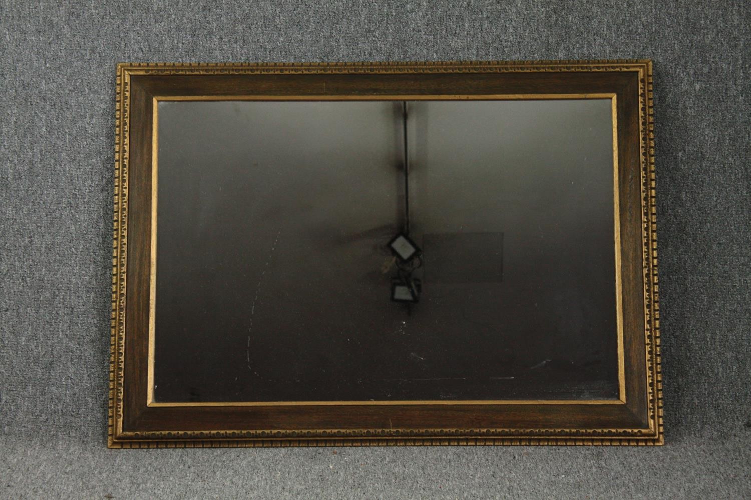 A contemporary gilt framed wall mirror. H.78 W.108cm.