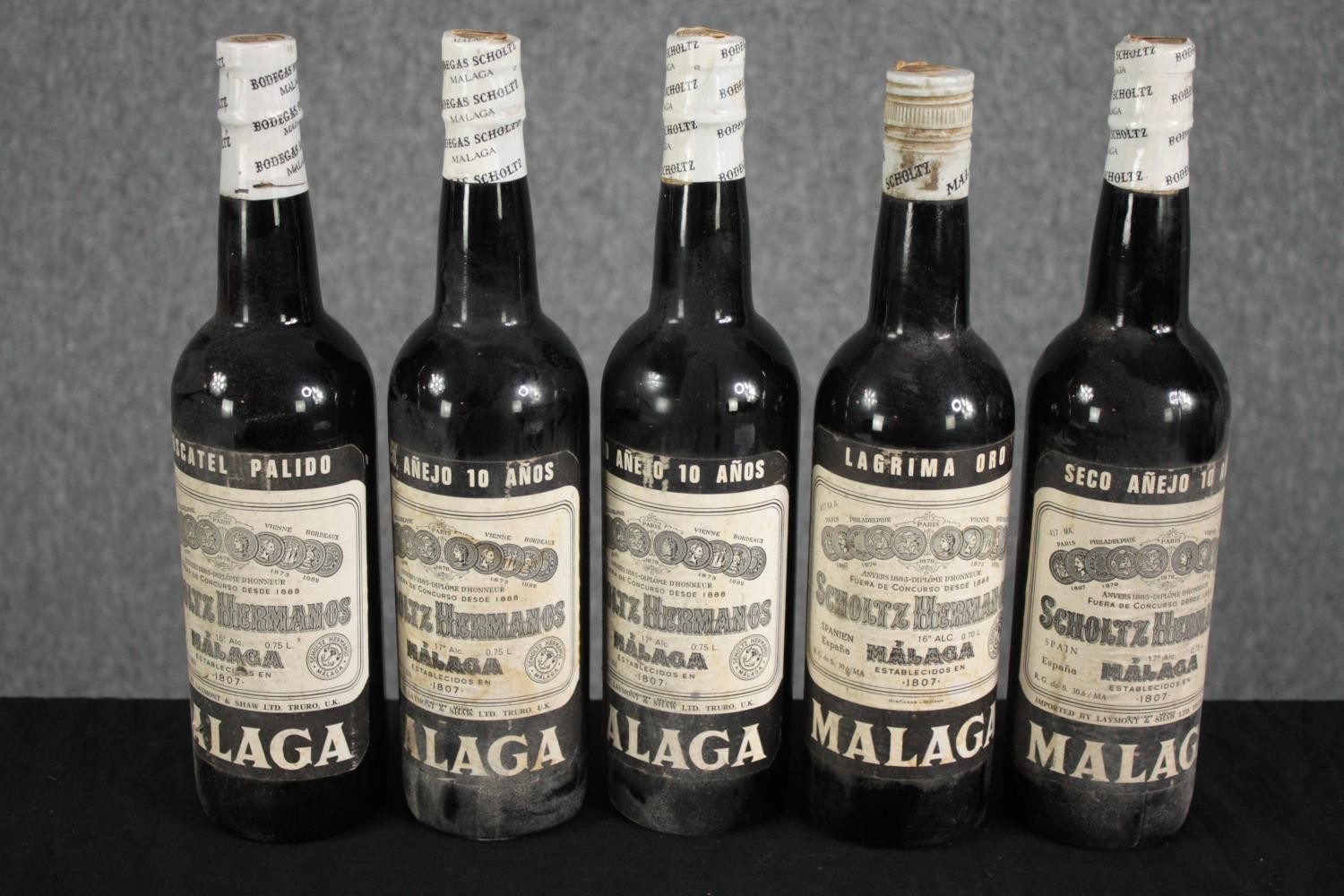 Five unopened bottles of Malaga sherry.
