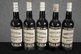 Five unopened bottles of Malaga sherry.