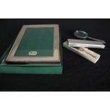 A Harrods sterling silver photo frame, a silver handled magnifying glass and collection of miniature