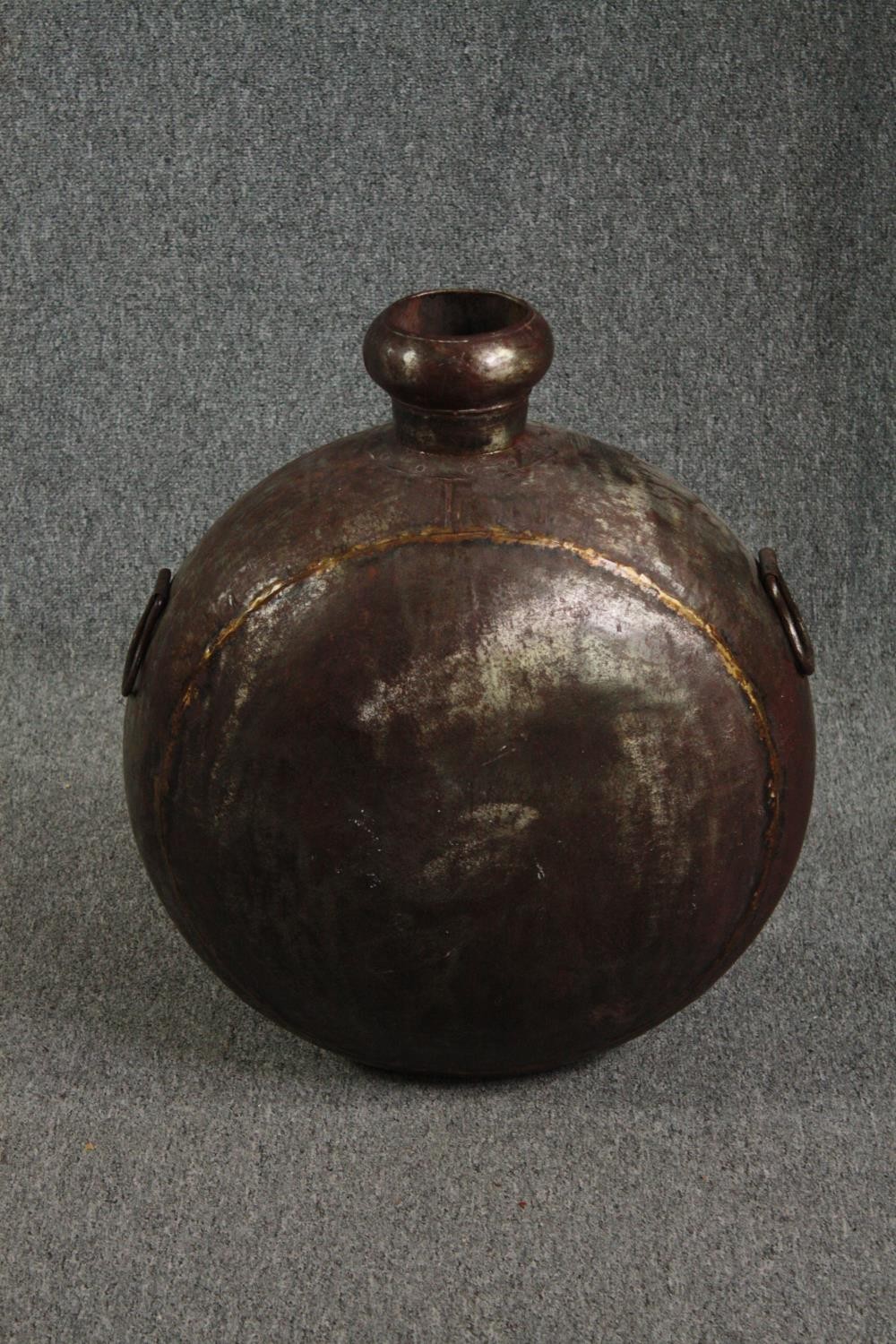 A brass flask. Probably late nineteenth century. H.61 W.52cm.