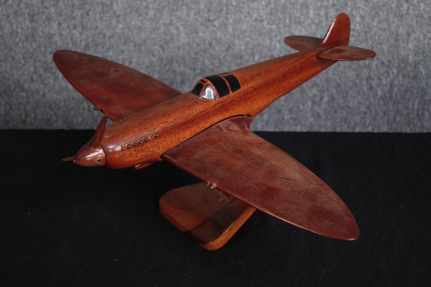 A large carved Supermarine Spitfire. Desk model. Missing one blade to its propeller and one - Image 4 of 4