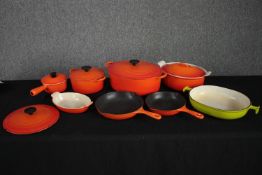 A mixed collection of classic Le Creuset cookware. Including ironware and ceramics. H.15 W.37cm. (