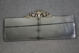 Wall mirror, contemporary bevelled glass with Rococo style cresting. H.54 W.120cm.