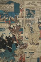A Japanese hand coloured woodcut. A dramatic scene showing a samurai worrier in the act of