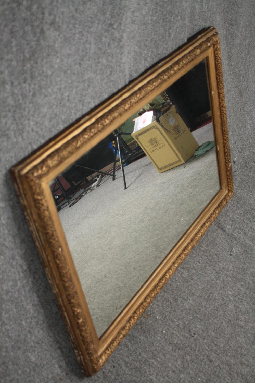 A 19th century gilt and gesso framed wall mirror with replacement plate. H.65 W.90cm. - Image 2 of 4
