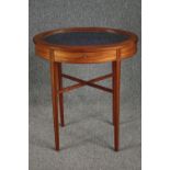 An Edwardian satinwood bijouterie display table with hinged glazed top on ebony strung tapering