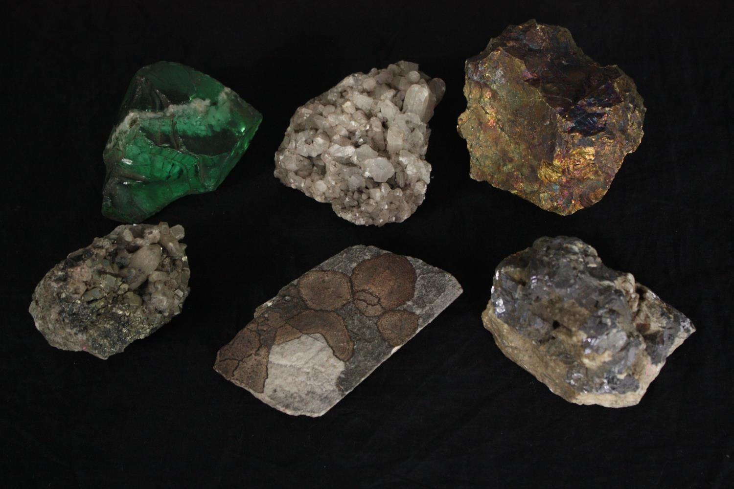 A collection of six minerals and a piece of slag glass. Minerals include Quartz and Iron Pyrites.