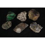 A collection of six minerals and a piece of slag glass. Minerals include Quartz and Iron Pyrites.