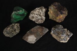 A collection of six minerals and a piece of slag glass. Minerals include Quartz and Iron Pyrites.