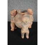 Terracotta 'rattle pot'. Tripod bowl supported by three figures. H.20cm.