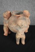 Terracotta 'rattle pot'. Tripod bowl supported by three figures. H.20cm.