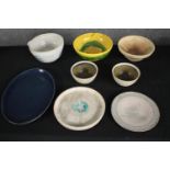A collection of five bowls and three plates in various glazes, some signed on the base. H.32 W.23cm.
