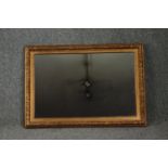 A 19th century gilt and gesso framed wall mirror with replacement plate. H.65 W.90cm.