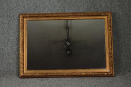 A 19th century gilt and gesso framed wall mirror with replacement plate. H.65 W.90cm.
