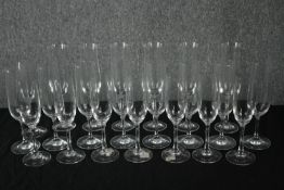 A collection of twenty-two Champagne glasses, one set by Dartington. H.23cm. (largest)