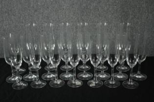 A collection of twenty-two Champagne glasses, one set by Dartington. H.23cm. (largest)