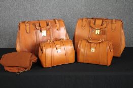 Two pairs of bespoke tan leather Gladstone bag style travel luggage. One larger and one smaller.