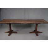 A Stewart Linford antique style oak refectory table with planked top and cleated ends on chamfered