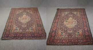 A pair of Persian Sarouk carpets the central flowerhead medallions on a sapphire ground within