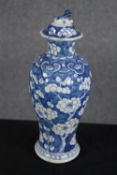 A hand painted lidded Chinese pot decorated with flowers. Twentieth century. H.28cm.