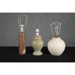 Three ceramic lamps. Including an old bottle stamped 'Amsterdam' that has been converted into a