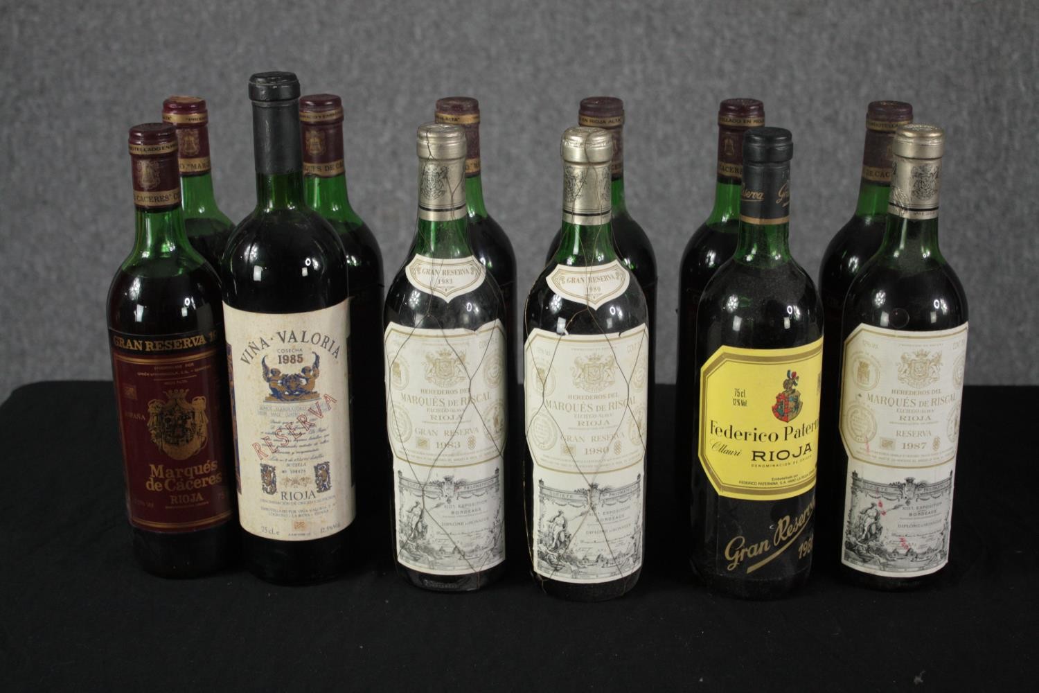 Twelve bottles of Rioja wine mostly dating from the 80s. Including Marques de Caceres and other