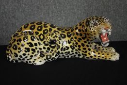 A hand painted ceramic Leopard. 'Made in Italy'. L.45cm.