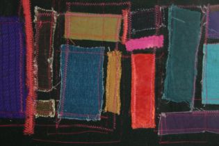 Embroidery art. An abstract composition behind a black background. Circa 1950. Signed 'M.R'.