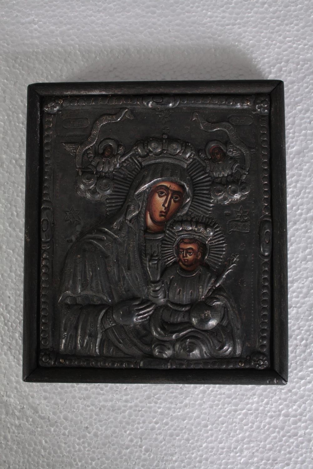 A 20th century oklad icon, hand painted Madonna and Child. H.18 W.16cm.