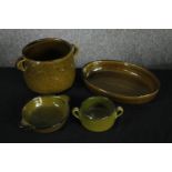 A mixed collection of green ceramic oven pots and bowls. Some with a makers mark to the base.