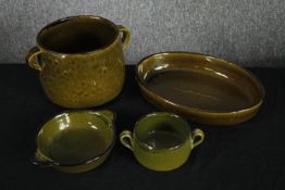 A mixed collection of green ceramic oven pots and bowls. Some with a makers mark to the base.