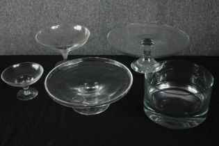 A collection of four glass cake stands and a bowl. H.13 Dia.31cm.