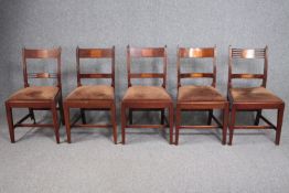 A harlequin set of five 19th century mahogany and satinwood bar back dining chairs.