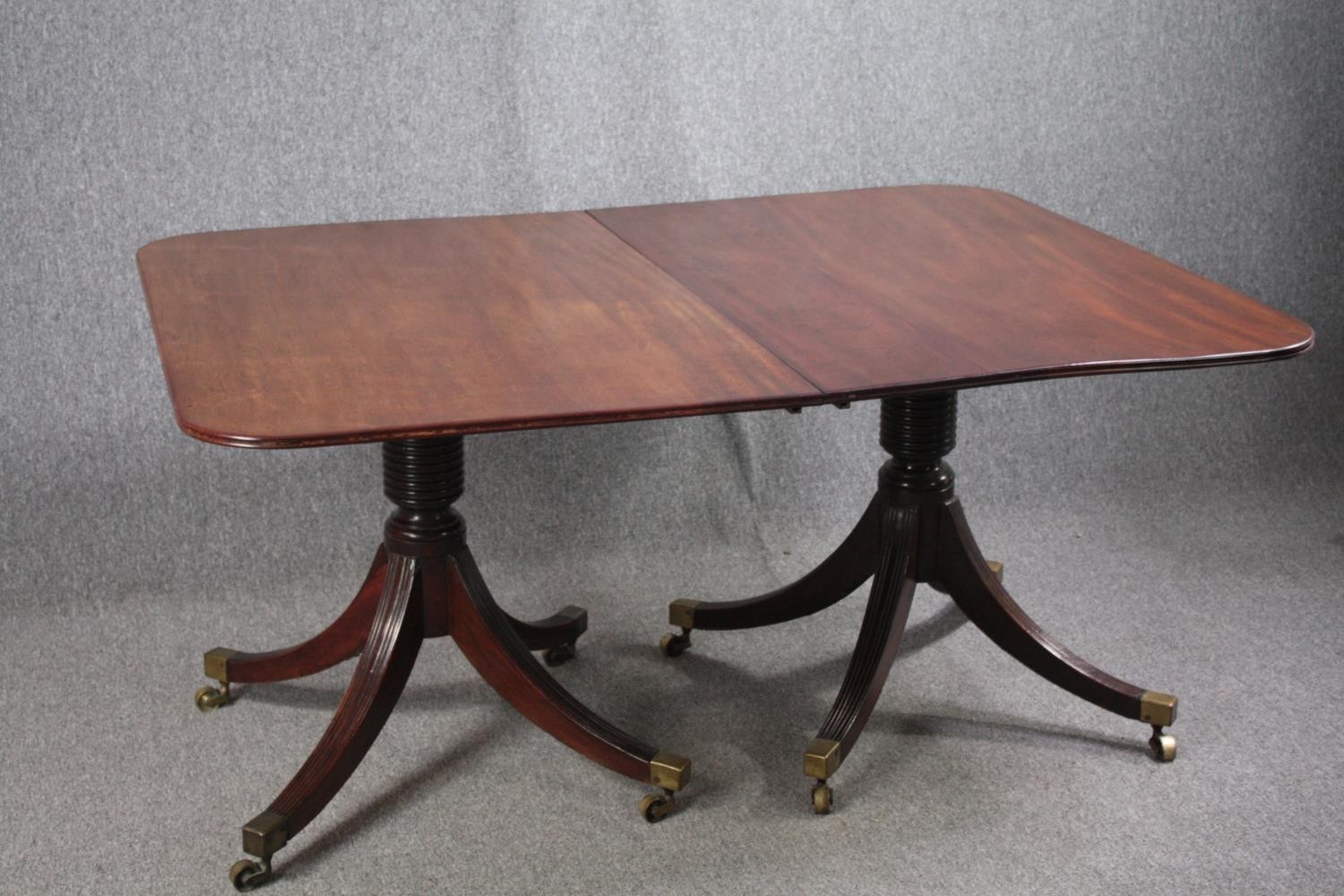 A George III mahogany twin pedestal dining table on quadruped swept supports terminating in brass - Image 2 of 5