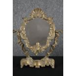 A vintage brass framed Rococo style vanity mirror. H.36 W.31cm.