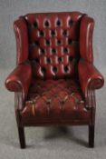 Wing back armchair, Georgian style deep buttoned leather upholstered. H.96cm. (Some wear as seen).