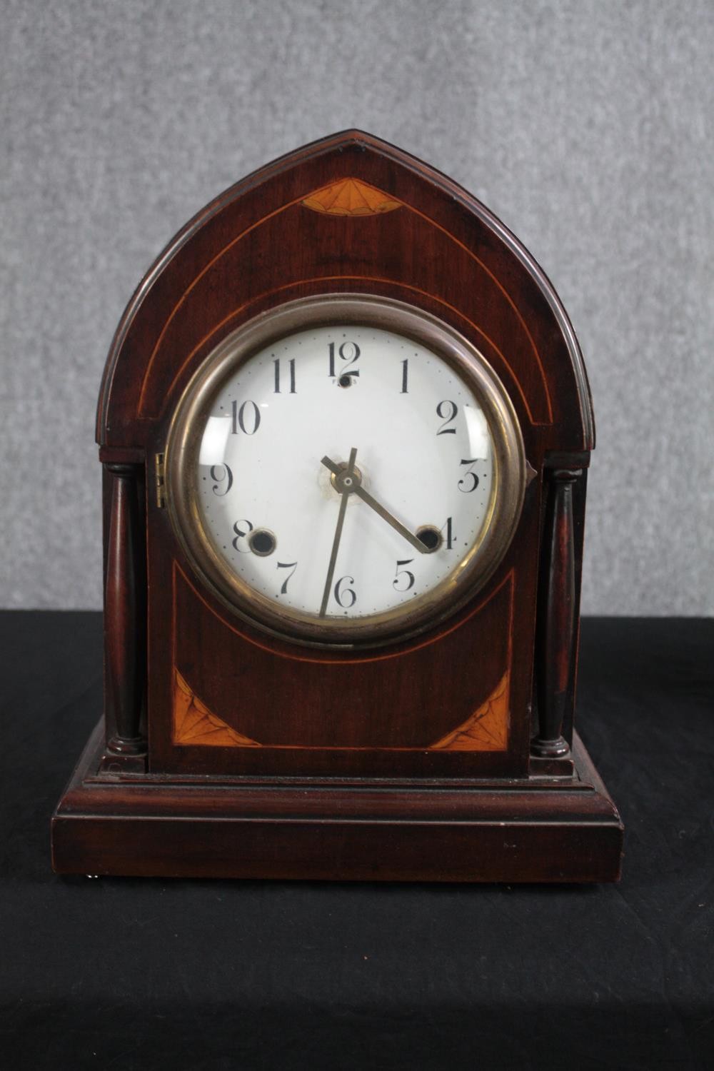 An Edwardian mahogany and satinwood mantel clock with a replacement modern movement. H.38 W.28 D.