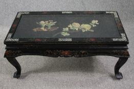A vintage lacquered Chinese coffee table with applied decoration and plate glass top. H.46 W.102 D.